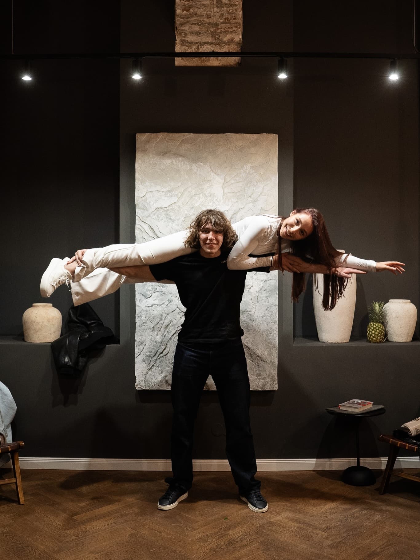 Playful couple portrait, one partner carried on the other's shoulders