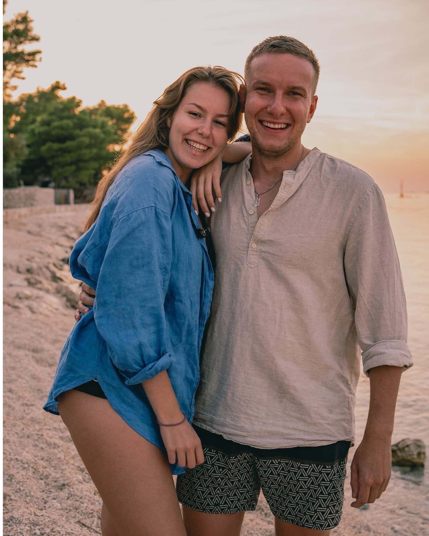 Couple embracing on the beach at sunset