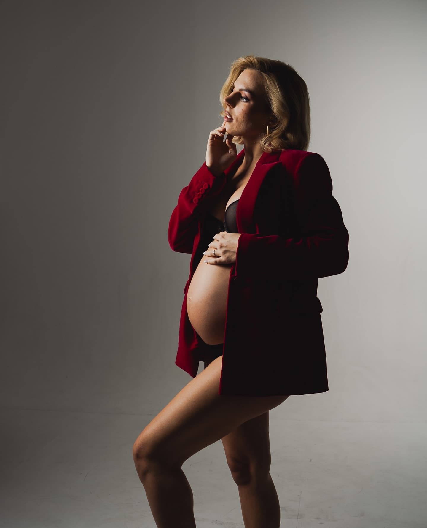 Studio maternity portrait in dramatic light