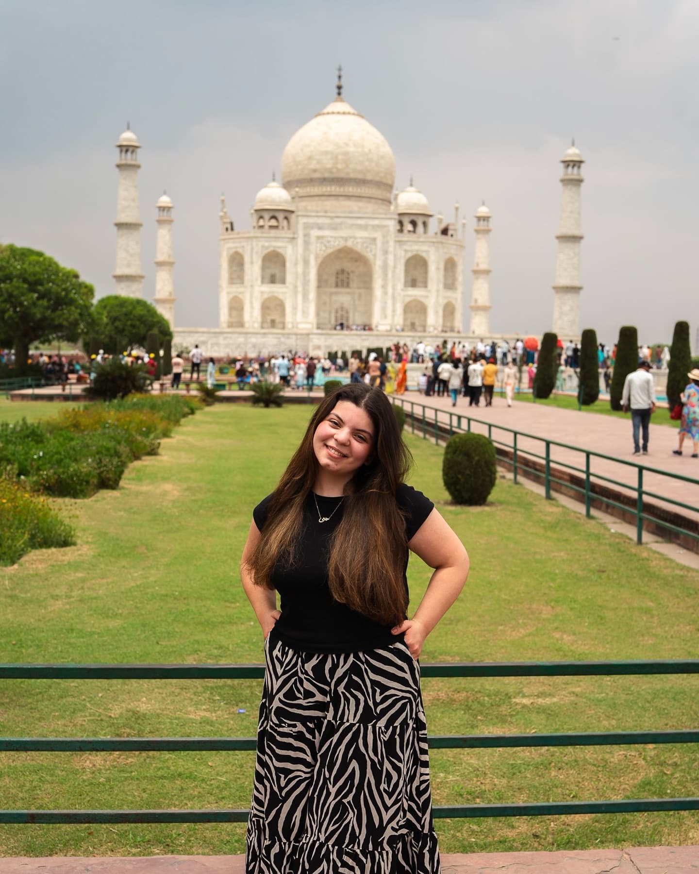 Travel portrait of a woman in front of the Taj Mahal